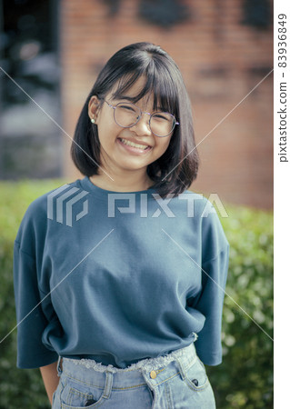 asian teenager toothy smiling face standing outdoor 83936849