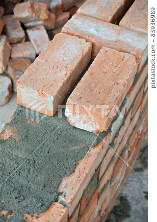 JASIN, MALAYSIA -SEPTEMBER 09, 2016: Clay brick walling joint and workmanship. Clay brick was attached together using cement mortar. JASIN, MALAYSIA -SEPTEMBER 09, 2016: Clay brick walling joint and workmanship. Clay brick was attached together using cement mortar. 83936989