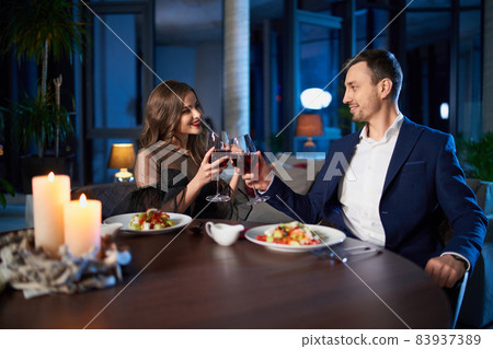 Beautiful lovely couple having romantic dinner at home Beautiful lovely couple having romantic dinner at home 83937389