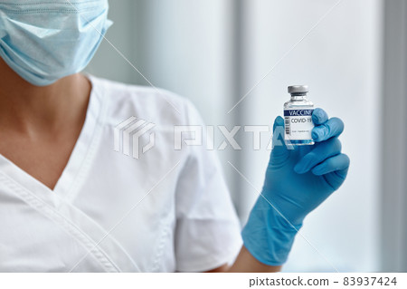 Female doctor holding COVID-19 vaccine in hand. Healthcare And Medical concept. Female doctor holding COVID-19 vaccine in hand. Healthcare And Medical concept. 83937424