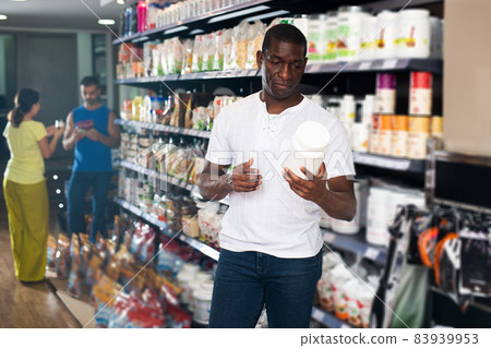 Athletic African looking for necessary food supplements 83939953