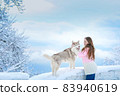 Woman on a winter walk with a husky dog 83940619