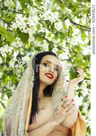 young pretty indian girl in jewelry and veil posing cheerful happy smiling in green park, lifestyle people concept young pretty indian girl in jewelry and veil posing cheerful happy smiling in green park, lifestyle people concept 83940621