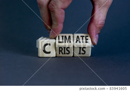 Climate crisis and change symbol. Businessman turns wooden cubes with words 'Climate crisis'. Beautiful grey background. Climate change and ecological crisis concept. Copy space. 83941605