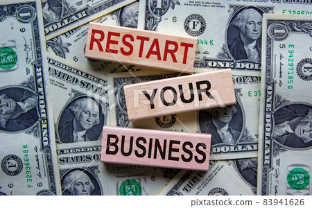 Concept text 'restart your business' on wooden blocks on a beautiful background from dollar bills. 83941626