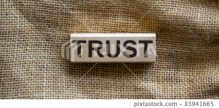 Wooden block form the word 'trust' on beautiful canvas background. Business concept. Wooden block form the word 'trust' on beautiful canvas background. Business concept. 83941665