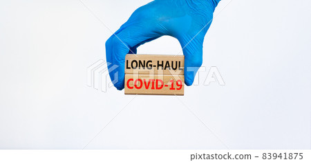 COVID-19 long-haul covid symptoms symbol. Wooden blocks words Long-haul covid-19. Doctor hand, blue glove, beautiful blue background, copy space. Medical, COVID-19 long-haul covid-19 symptoms concept. COVID-19 long-haul covid symptoms symbol. Wooden blocks words Long-haul covid-19. Doctor hand, blue glove, beautiful blue background, copy space. Medical, COVID-19 long-haul covid-19 symptoms concept. 83941875
