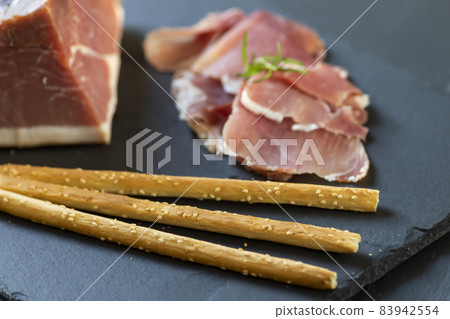 Italian ham served with grissini Italian ham served with grissini 83942554