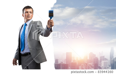 Creative businessman painter holding paintbrush Creative businessman painter holding paintbrush 83944160