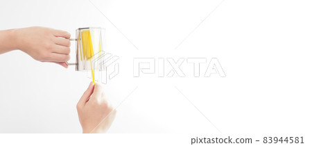 Clean and wash dish concept. Man hand washing drink glass on white background. Used drinking glass cleaning by soft yellow sponge stick. Wash cup by sponge brush. Disinfection hyginic in covid 19 era 83944581