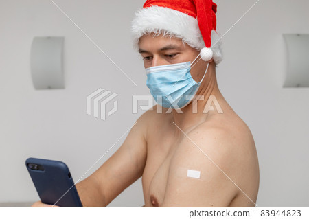 man with mask and patch on shoulder taking selfie 83944823