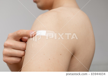 happy man pointing at the patch on shoulder happy man pointing at the patch on shoulder 83944834