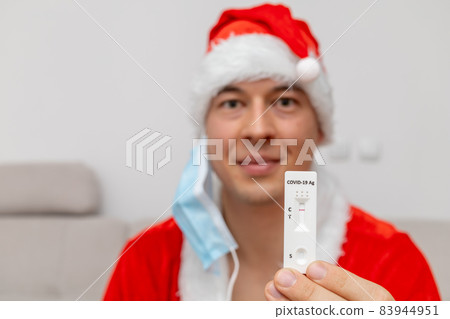 happy man dressed in Santa Claus hat showing negative test result happy man dressed in Santa Claus hat showing negative test result 83944951