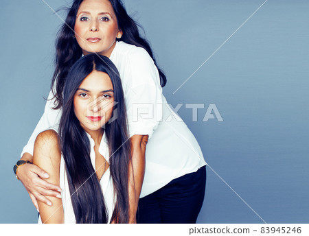cute pretty teen daughter with mature mother hugging, fashion style brunette, lifestyle people concept cute pretty teen daughter with mature mother hugging, fashion style brunette, lifestyle people concept 83945246