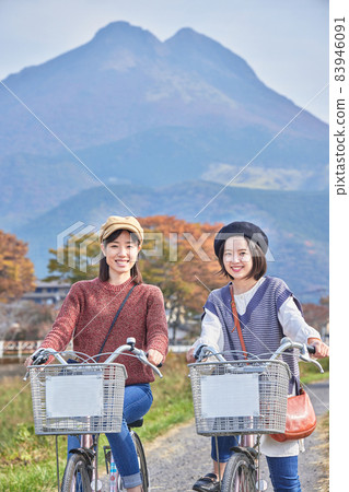 Young women and friends walking around Yufuin by bicycle Young women and friends walking around Yufuin by bicycle 83946091
