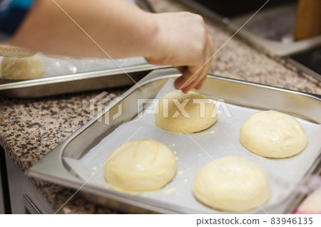 Preparing burger buns, making burgers. Preparing burger buns, making burgers. 83946135