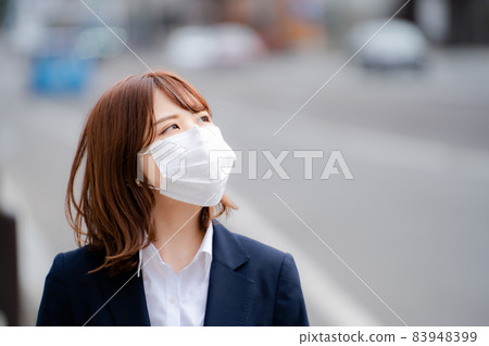 Business woman staring in a mask Business woman staring in a mask 83948399