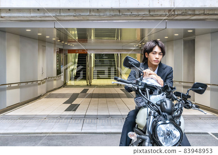 Young businessman and large bike 83948953