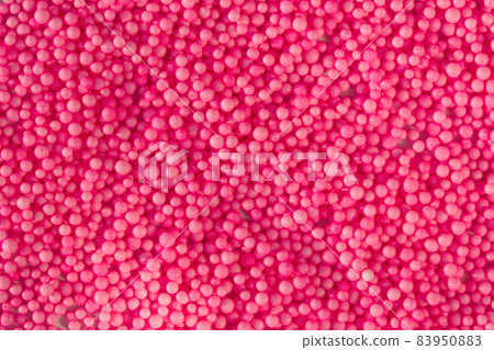 Many pink little balls for children playground. Cosmetics powder. Candy sprinkles. Top view. Trendy absract background or backplate for your design Many pink little balls for children playground. Cosmetics powder. Candy sprinkles. Top view. Trendy absract background or backplate for your design 83950883