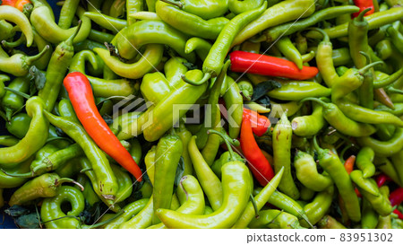 Close-up on a shelf with green and red peppers in the market. Close-up on a shelf with green and red peppers in the market. 83951302
