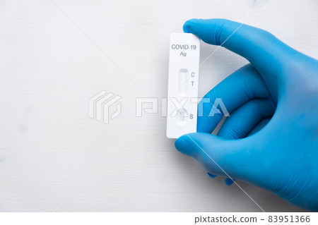 Covid-19 antigenic test for quick detection of disease in doctors hand in the rubber gloves with copy space. Coronavirus test cassette from rapid strep kit Covid-19 antigenic test for quick detection of disease in doctors hand in the rubber gloves with copy space. Coronavirus test cassette from rapid strep kit 83951366