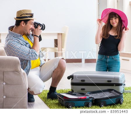 Young family packing for vacation travel Young family packing for vacation travel 83951443