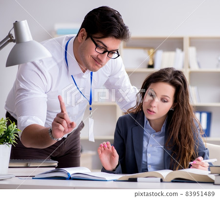 Teacher explaining to student at lecture Teacher explaining to student at lecture 83951489