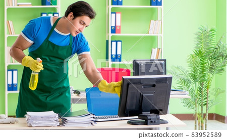 Male handsome professional cleaner working in the office 83952589