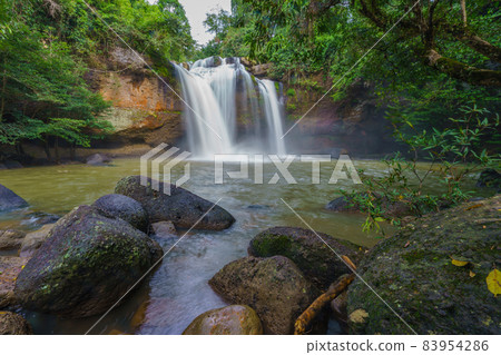 Beautiful waterfall with sunlight in jungle, Haew Suwat Waterfall at khao yai Nakhonratchasima province Beautiful waterfall with sunlight in jungle, Haew Suwat Waterfall at khao yai Nakhonratchasima province 83954286