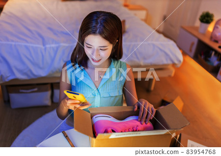 woman open delivery boxes woman open delivery boxes 83954768