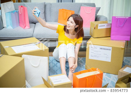 woman open delivery boxes woman open delivery boxes 83954773