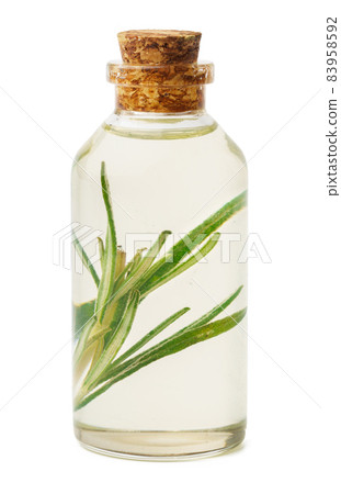 Essential oil in a small bottle with green leaf on white background Essential oil in a small bottle with green leaf on white background 83958592
