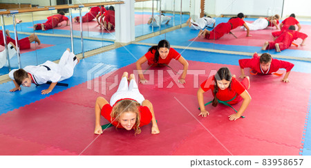 Karate kids doing push-ups in gym 83958657