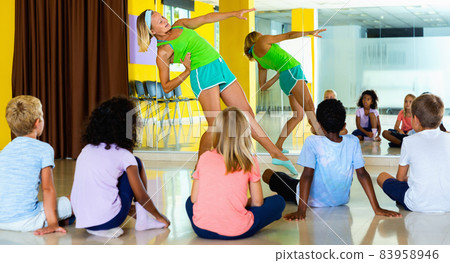 Experienced positive dance instructor teaching preteen boys and 83958946
