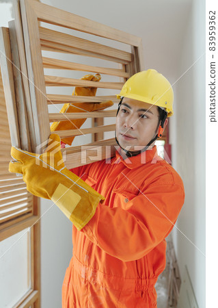 Builder Carrying Wooden Grates 83959362