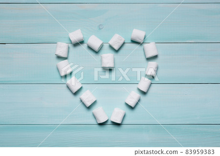 marshmallow on the azure board is laid out in the form of a heart, the concept of friendship and love 83959383