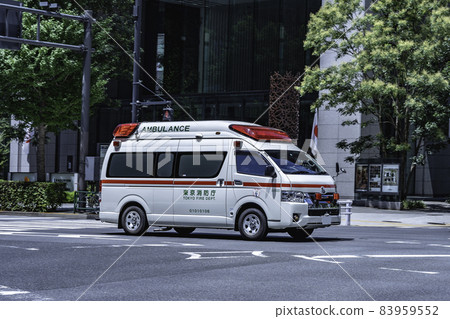 An emergency vehicle (ambulance) that sounds a siren and runs in the city An emergency vehicle (ambulance) that sounds a siren and runs in the city 83959552