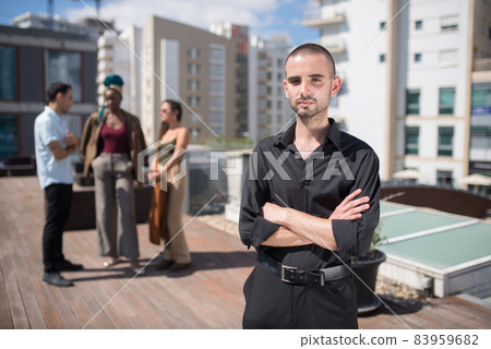 Serious young man at terrace roof party Serious young man at terrace roof party 83959682