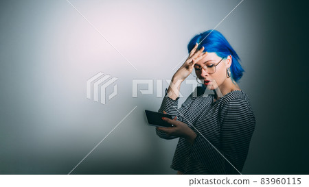 Phone problem. Spam message. Cyber bullying. Stressed frustrated woman with cell mockup screen on light dark spotlight gradient copy space background. 83960115