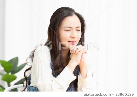 A housewife who sits in the living room and joins hands to ask 83960159