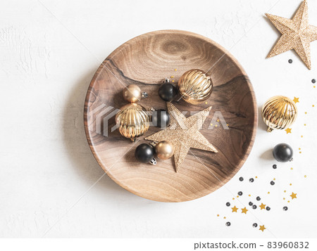 Christmas or New Year background - wooden plate with various Christmas balls and gold star on white background. 83960832