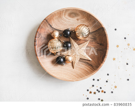 Christmas or New Year background - wooden plate with various Christmas balls and gold star on white background. 83960835