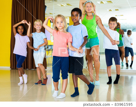 Positive little boys and girls dancing pair dance in the ballet studio Positive little boys and girls dancing pair dance in the ballet studio 83961595