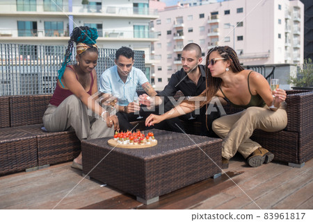 Positive colleagues on terrace roof party Positive colleagues on terrace roof party 83961817