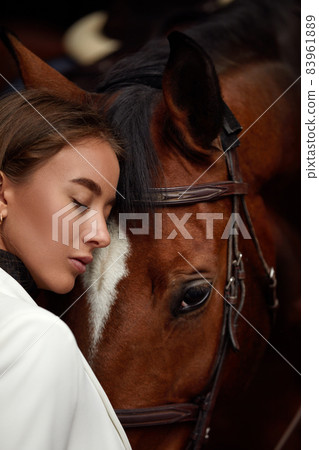 portrait beautiful woman long hair next horse 83961889