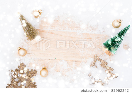 Christmas wood snow. Xmas board with old rustic wall, white frozen snowflake, golden balls and gift box. Winter wooden decoration background. Happy new year copy space. Christmas wood snow. Xmas board with old rustic wall, white frozen snowflake, golden balls and gift box. Winter wooden decoration background. Happy new year copy space. 83962242