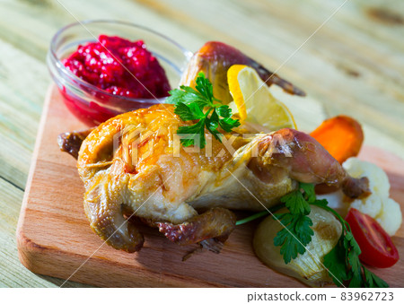 Roasted partridge with cranberry sauce and grilled vegetables 83962723