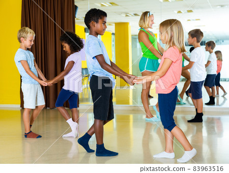 Little boys and girls dancing pair dance in the ballet studio 83963516