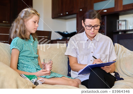 Serious sad child girl and female psychologist teacher at session 83964346