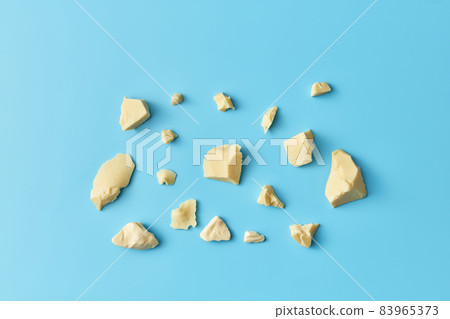 Pile of raw cocoa butter chunks 83965373